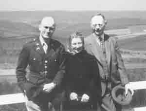 A woman standing between two men outside