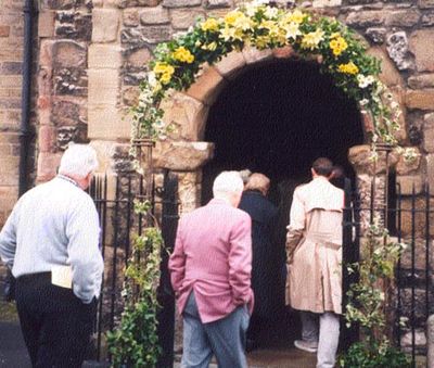 Three men walking into a church